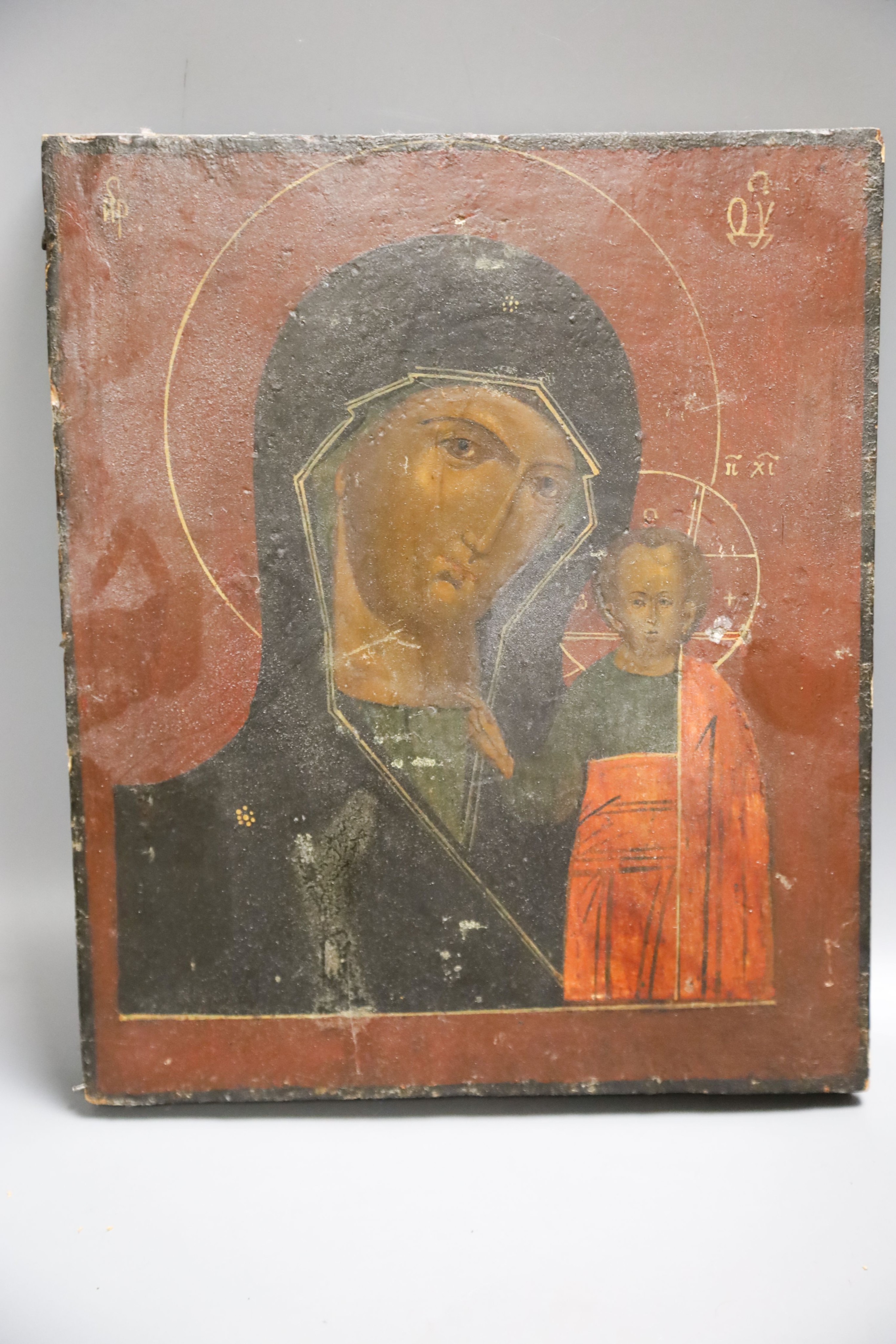 A Russian base metal oklad icon and a similar enamelled bronze panel, once part of a tryptich 27x23cm